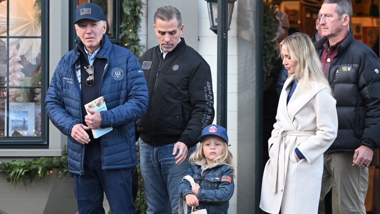 President Joe Biden walks out of Nantucket Bookworks with son Hunter Biden, grandson Beau and daughter-in-law Melissa Cohen Biden in Nantucket, Mass., on Nov. 29. Biden is holding the book <i>The Hundred Years' War on Palestine</i> by Rashid Khalidi. 