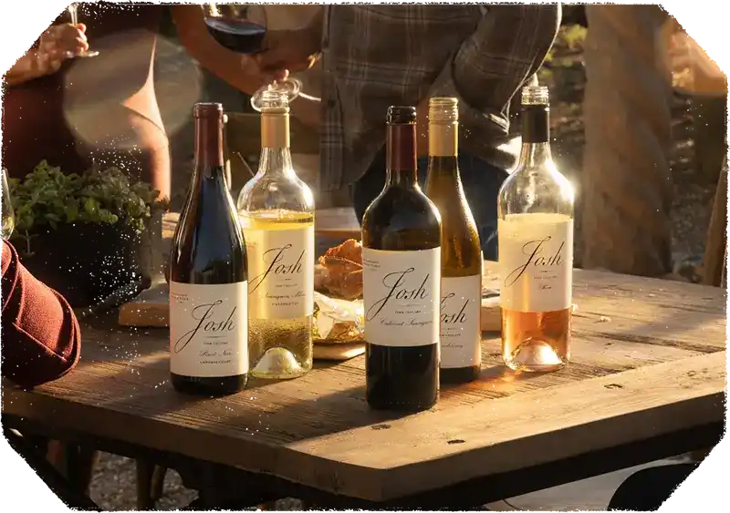 Several bottles of Josh wine arranged on a wooden surface.