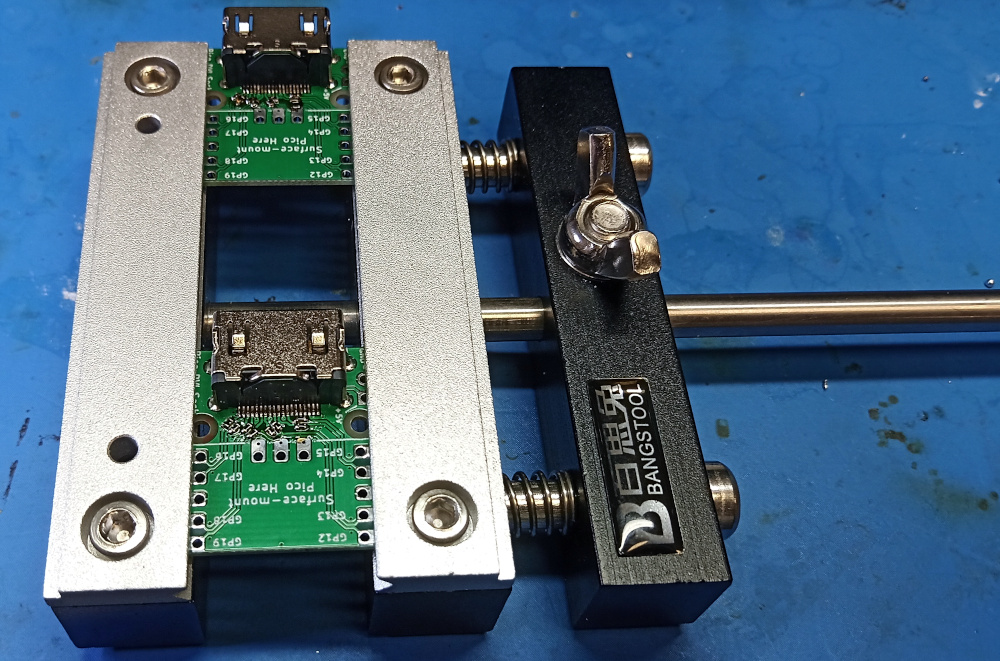 A stickvise gripping two smol PCBs and holding them steady for soldering