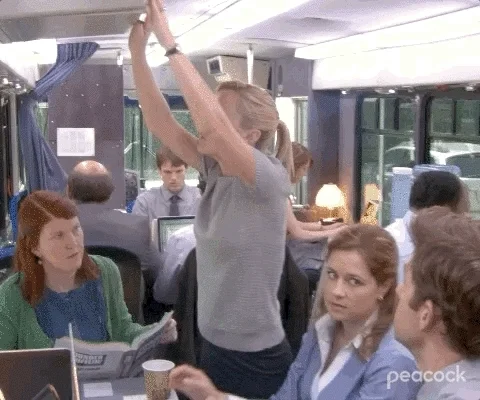 Angela (from The Office) opening a container and dropping a lot of paper on Pam