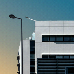 A building with a dithered gradient of the sky behind it. A jet airplane is taking off in the sky.