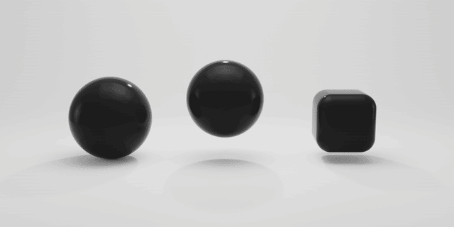 two spheres and a cube in a white environment animated using the wiggle driver function in Blender