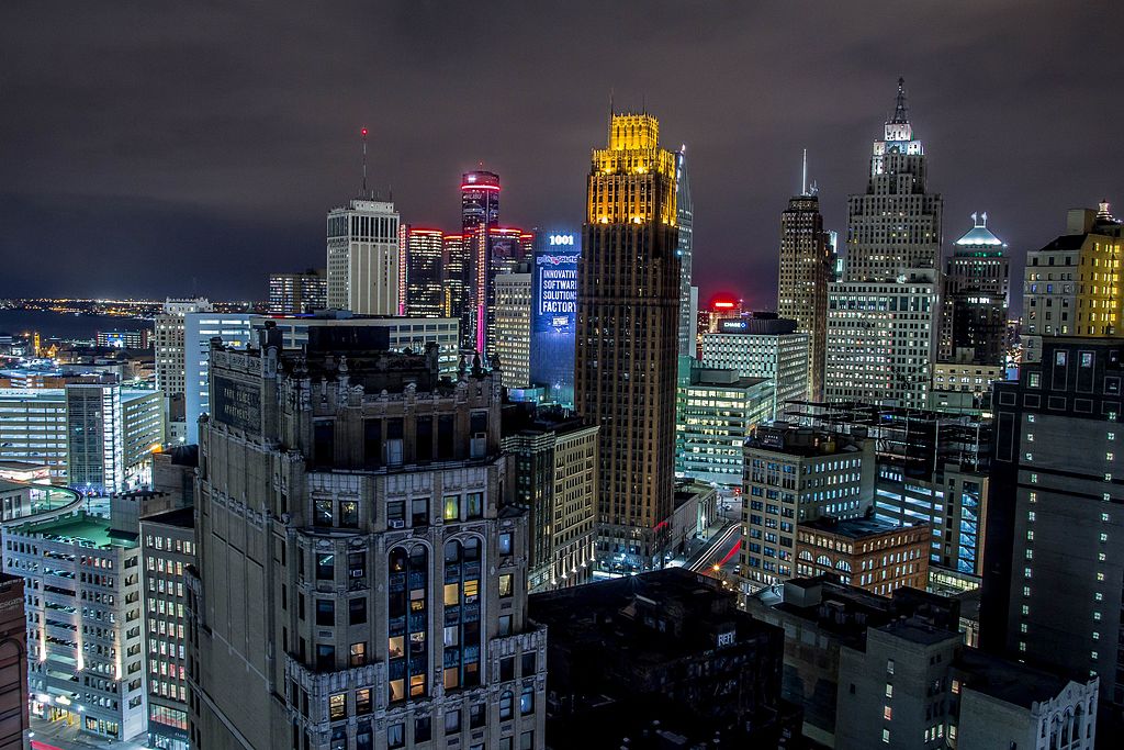 A photo of Downtown Detroit taken at night with several prominent and historic buildings shown
