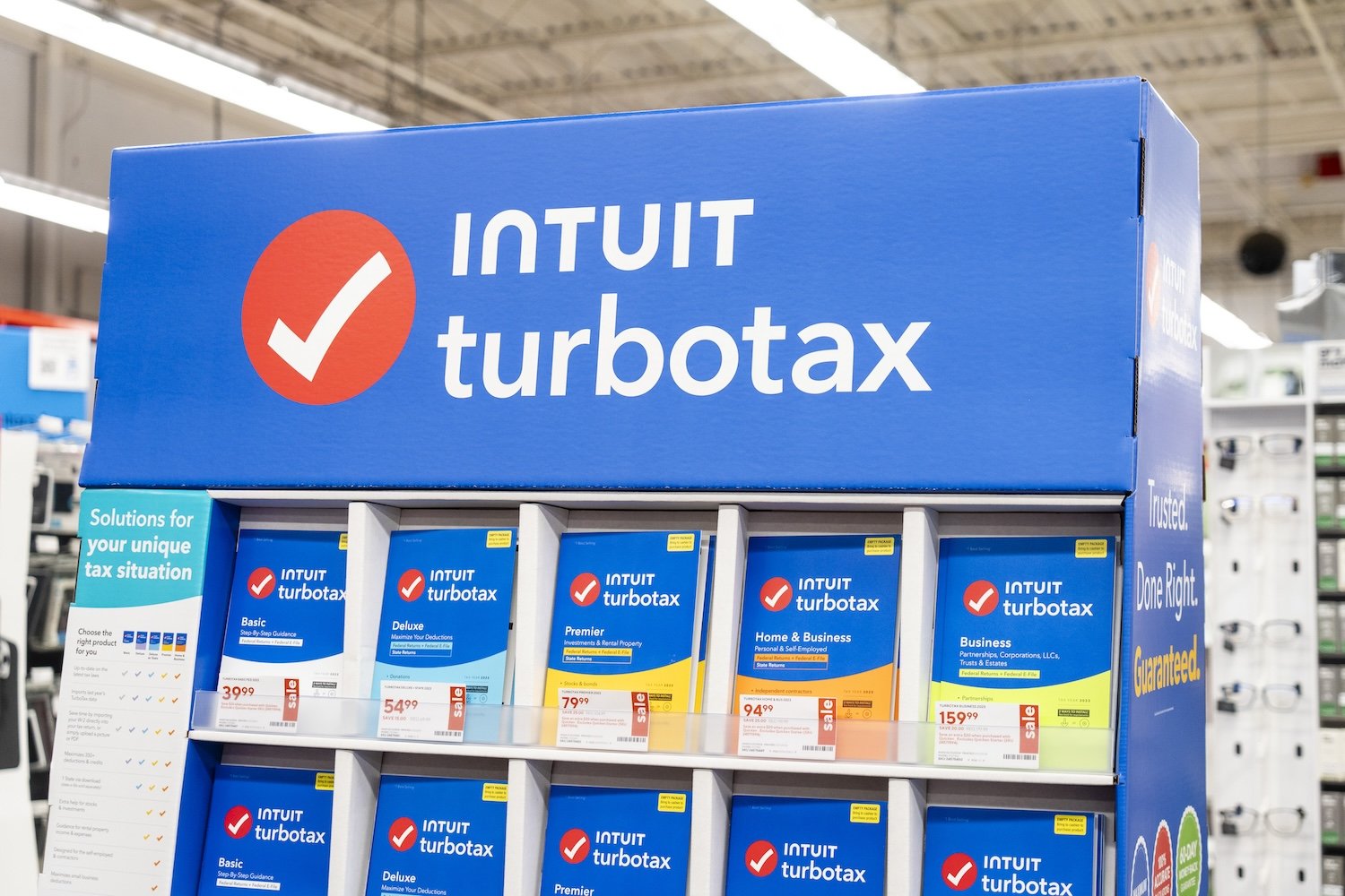 Stack of Intuit Turbotax software packages in a store.