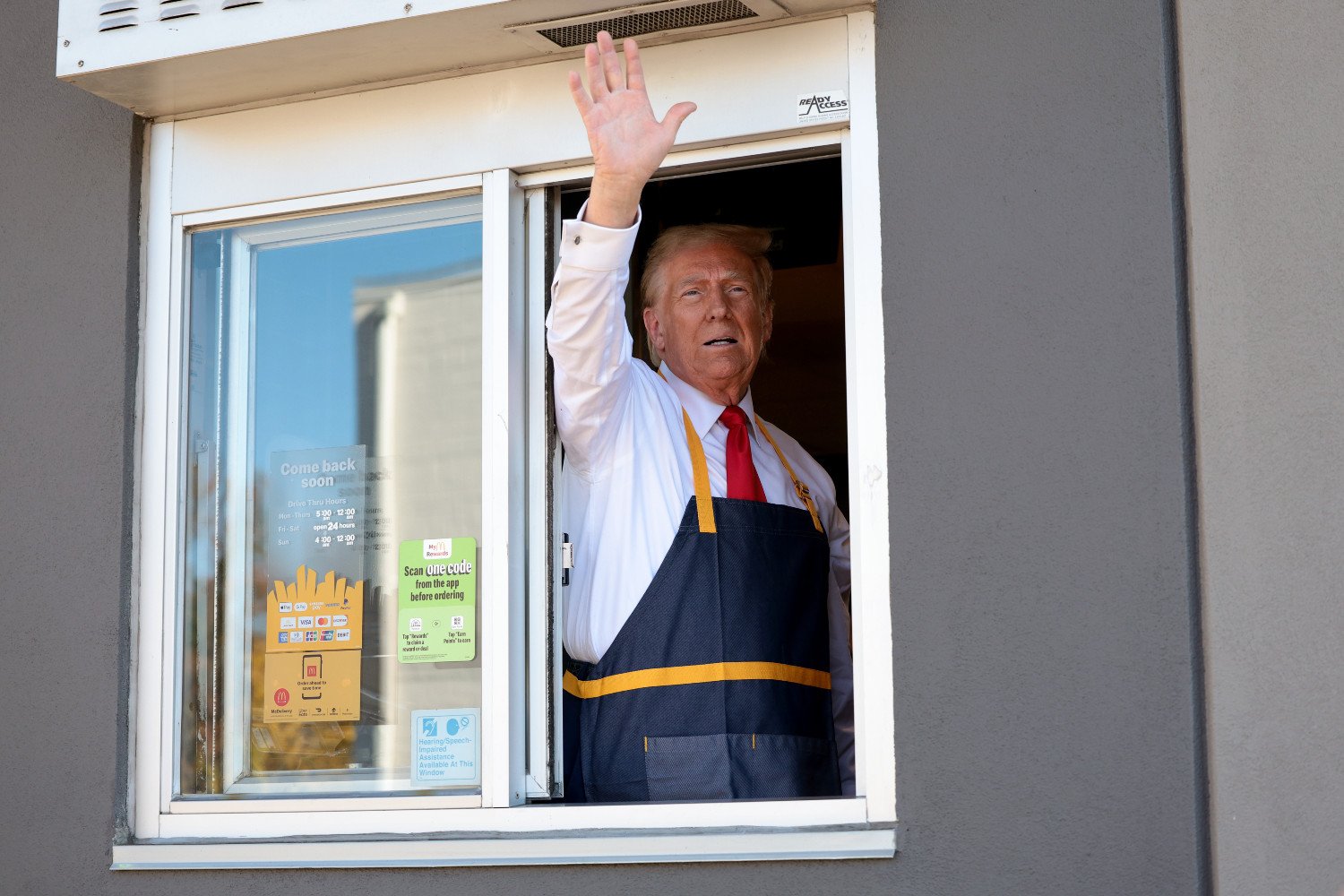 Donald Trump "works" the drive-through line during a campaign photo op as he visits a McDonald's restaurant on October 20, 2024 in Feasterville-Trevose, Pennsylvania.