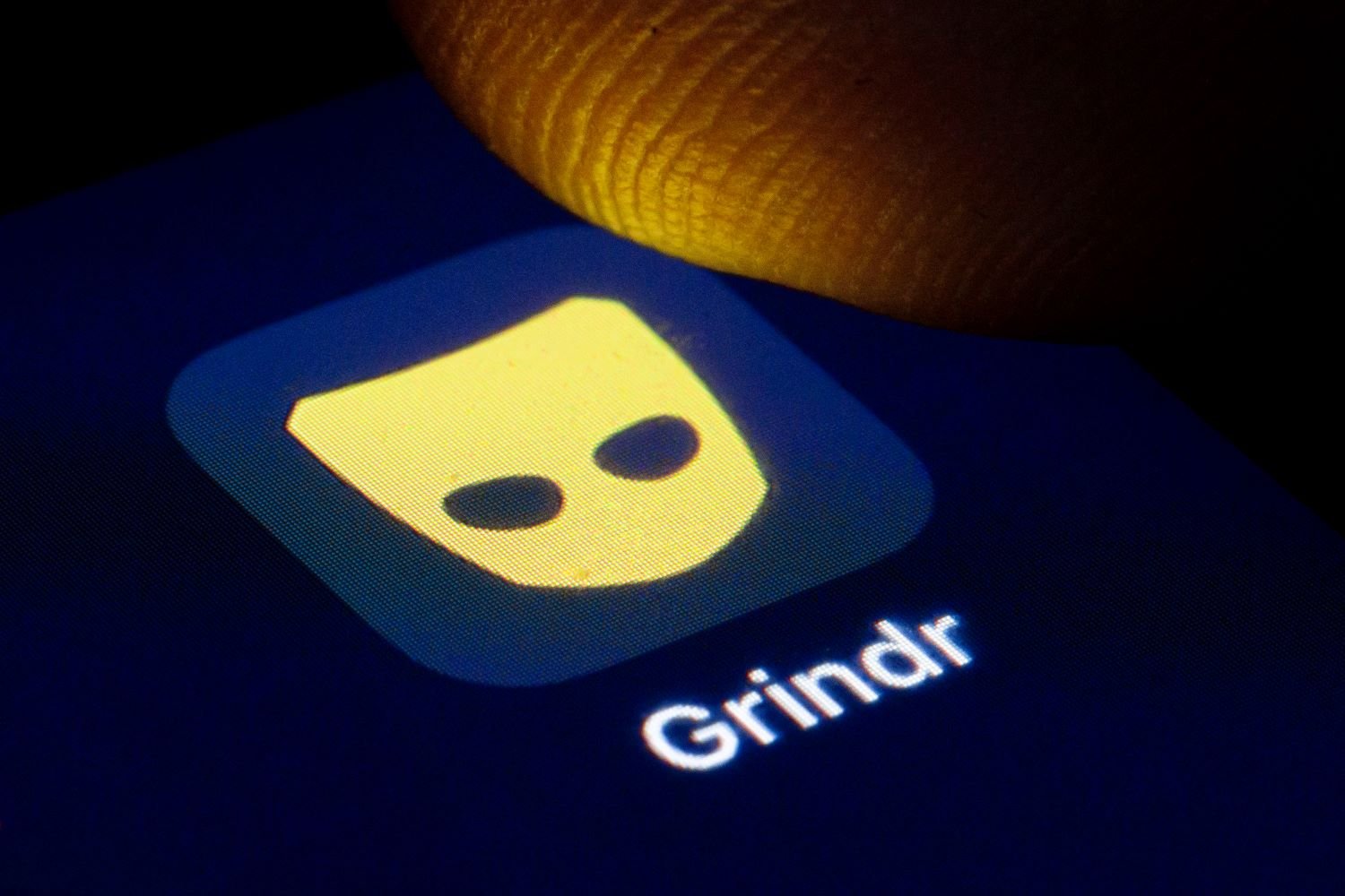 The Grindr app logo on a phone