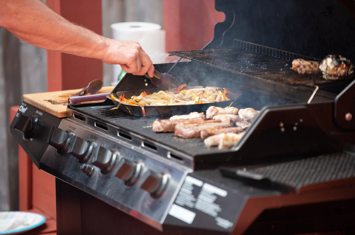 Man Grilling Different Meats 