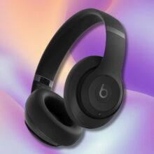 black beats studio pro headphones on a purple, light blue, and yellow wavy background