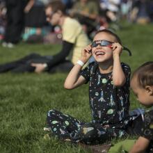 Child watching a total solar eclipse