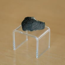 A chunk of the Lafayette meteorite on a clear stand