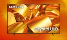 A Samsung TV appears on an orange and yellow abstract background, with golden ribbons on its screen.