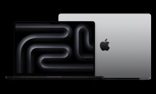 the 14- and 16-inch m4 apple macbooks pros against a black background