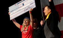 SpaceX and Tesla founder Elon Musk awarded Kristine Fishell with a $1 million check during the town hall at the Roxain Theater on October 20, 2024 in Pittsburgh, Pennsylvania.