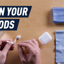 hands cleaning airpods with cotton swab