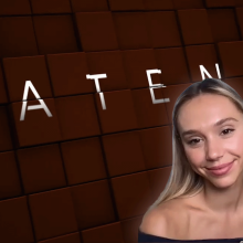 Alexis Ren smiling in front of the film's poster art