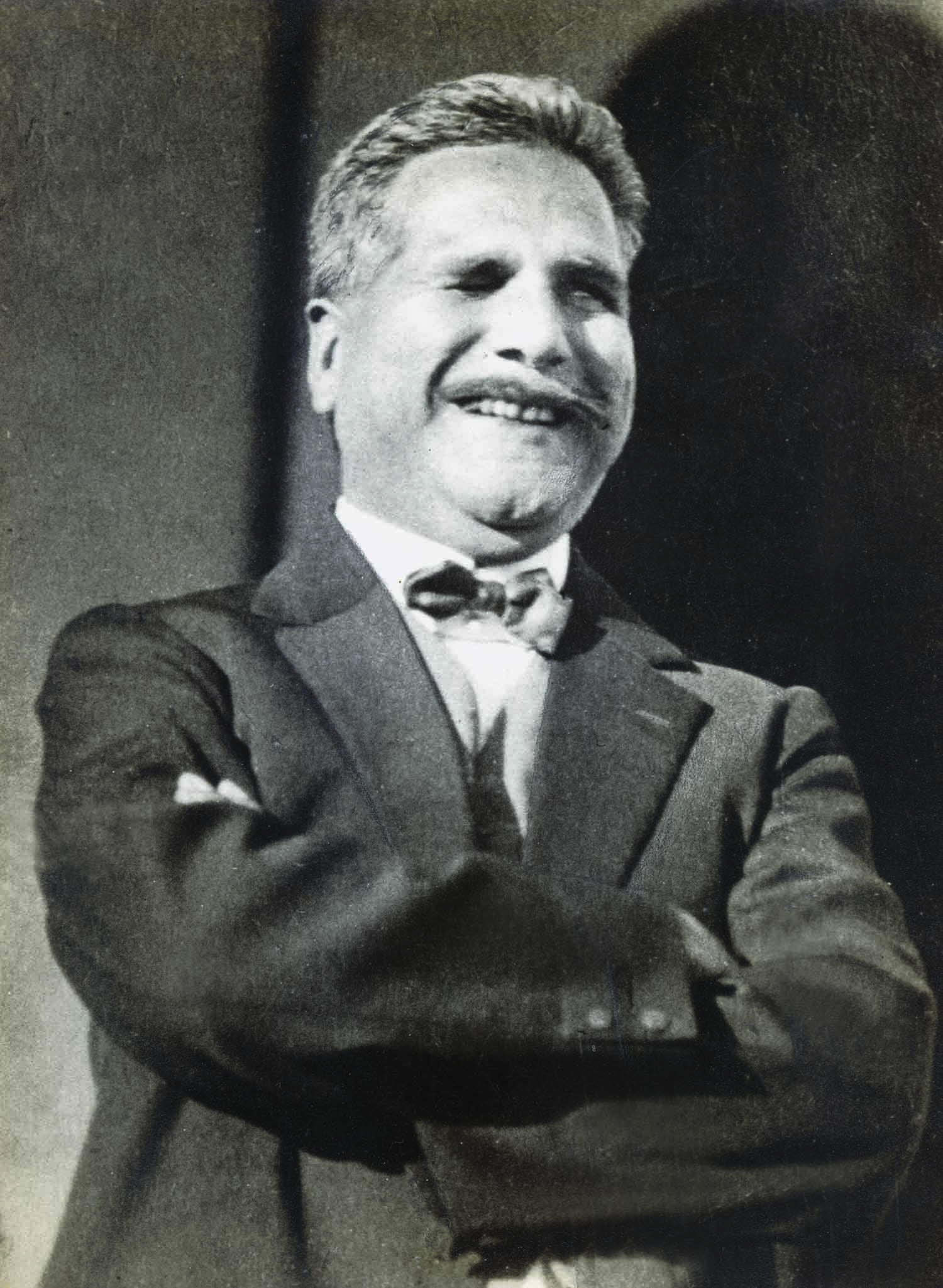 ELEGANTLY dressed in a suit, Allama Iqbal is seen having a lighter moment. | Photo: The Allama Iqbal Collection