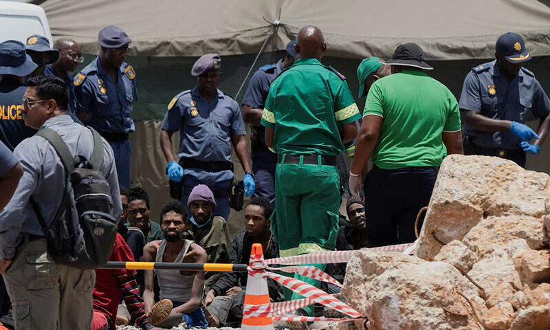 Rescued miners are seen as they are processed by police after at the mine shaft where operations are ongoing to rescue illegal miners who have been underground for months in Stilfontein, South Africa on January 14. — Reuters