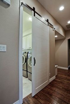 Washer and dryer hidden in closet with beautiful dark wooden doors ...