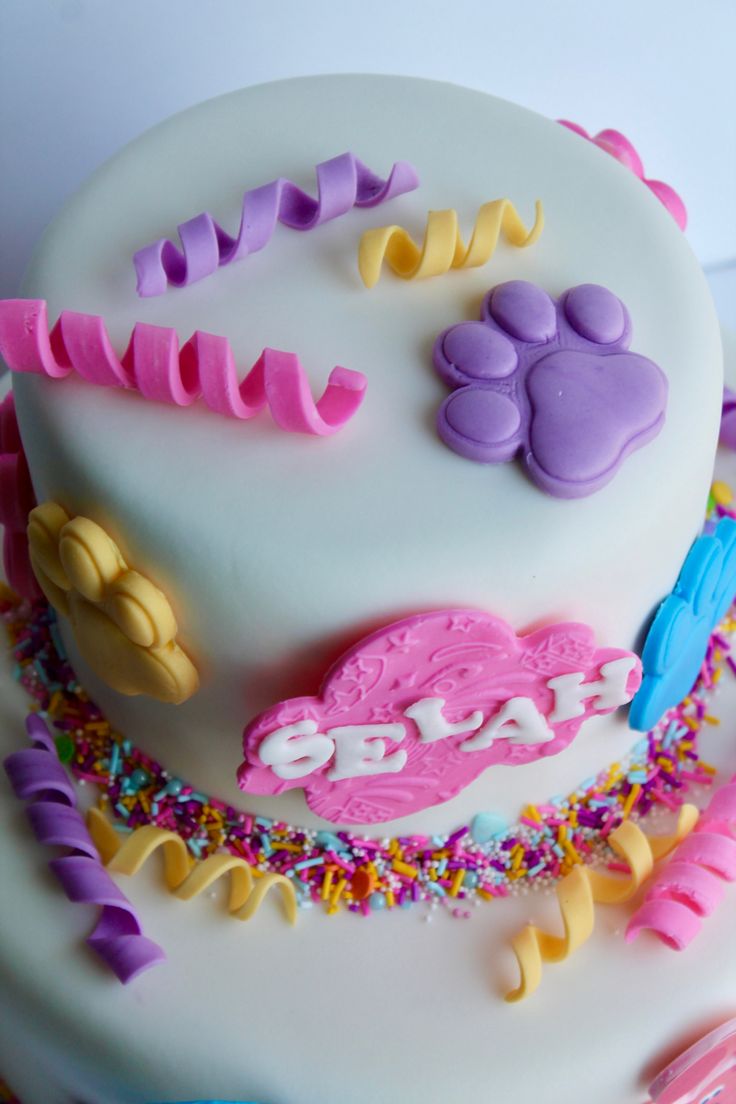 a white cake with colorful frosting and decorations