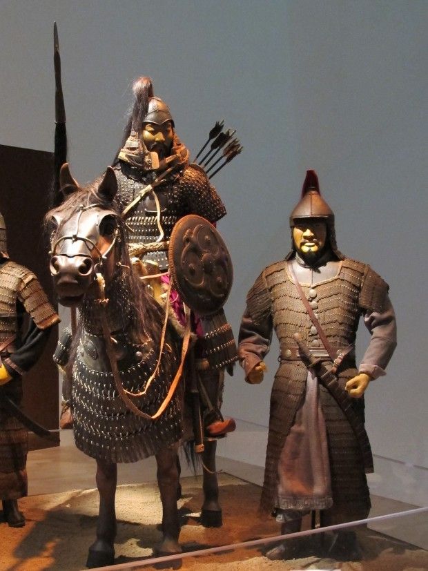 three statues of men in armor on horseback