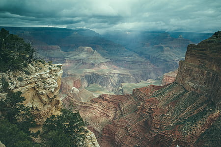 aerial view of canyons under cloudy sky