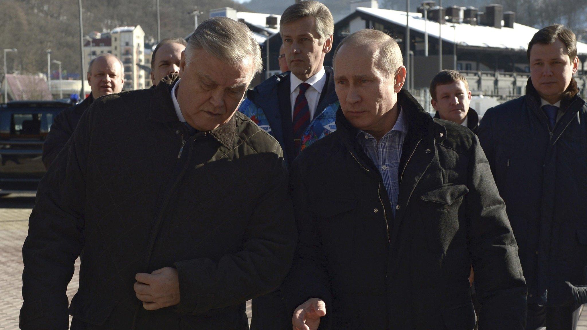 Russia's President Vladimir Putin (R) walks with Russian Railways President Vladimir Yakunin (L) during his visit to a recently constructed train station in Sochi (January 4, 2014)