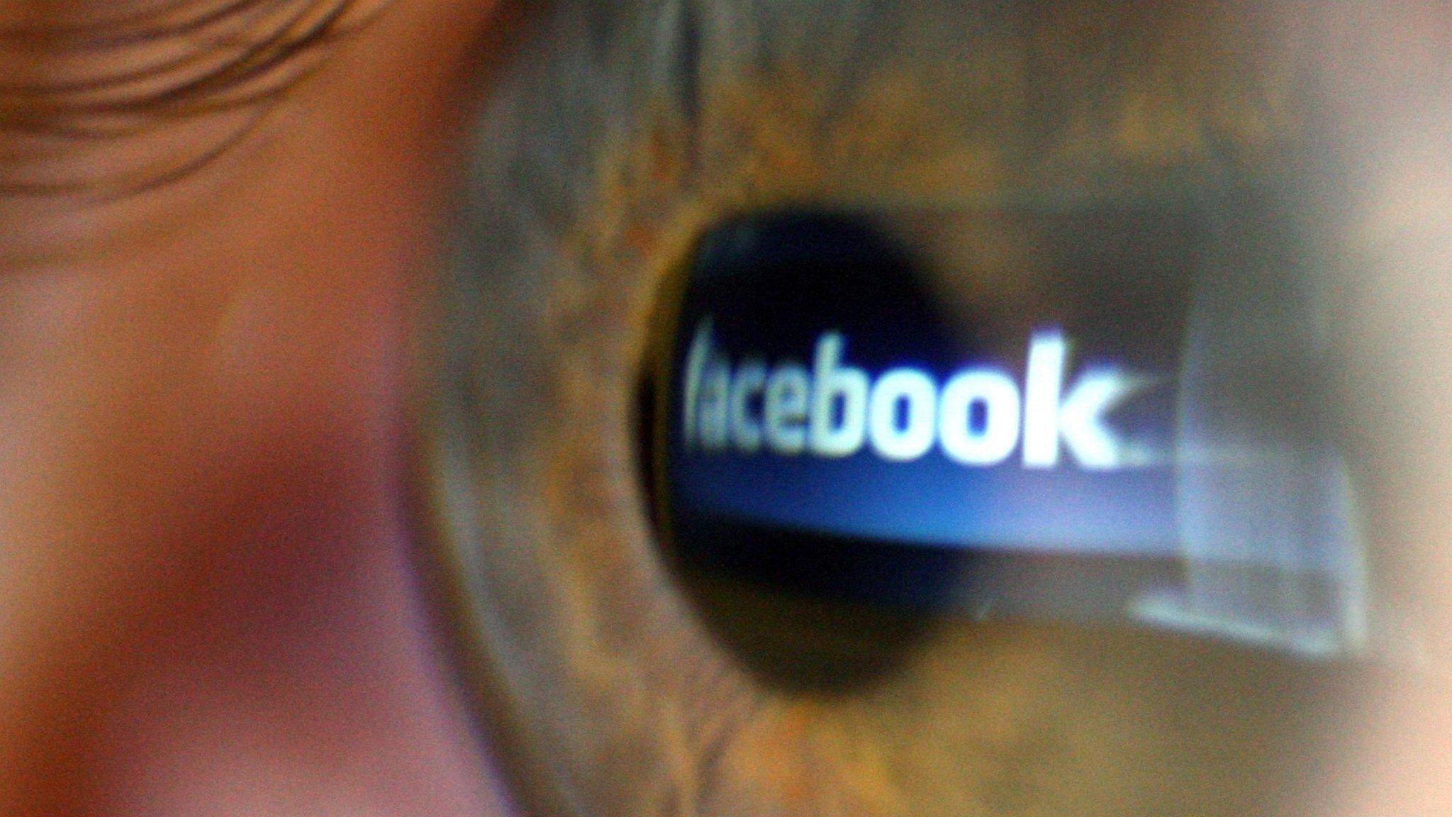 Facebook logo reflected on an eye