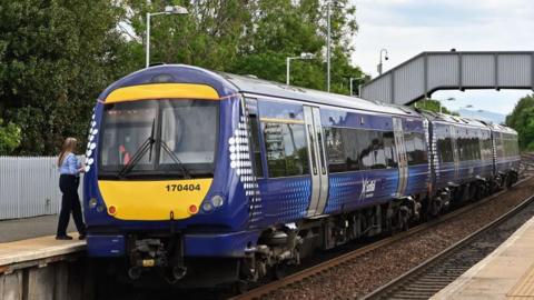 ScotRail train sitting at platform in train station