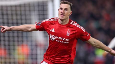 Chris Wood wheels away in celebration after putting Nottingham Forest ahead against Liverpool at The City Ground