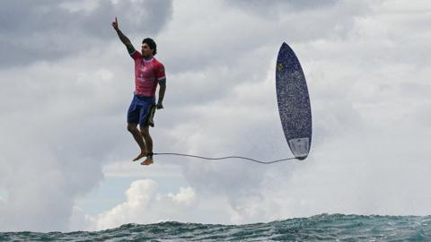 The third day of the surfing Olympic event in French Polynesia at Teahupo’o, Brazilian surfer Gabriel Medina gets the biggest wave of the competition and celebrates in a unique position by thanking God. July 29, 2024