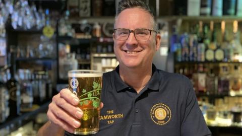 George Greenaway holding a pint