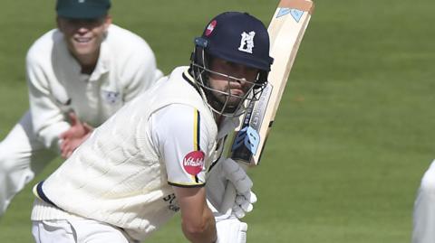 Will Rhodes looks to drive during his century for Warwickshire at Worcester