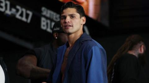 Ryan Garcia in a blue shirt as he prepares to weigh-in for a fight