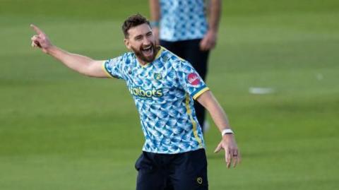 Richard Gleeson celebrates taking a wicket