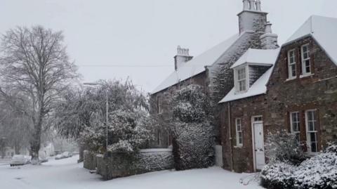 Country home blanketed in snow