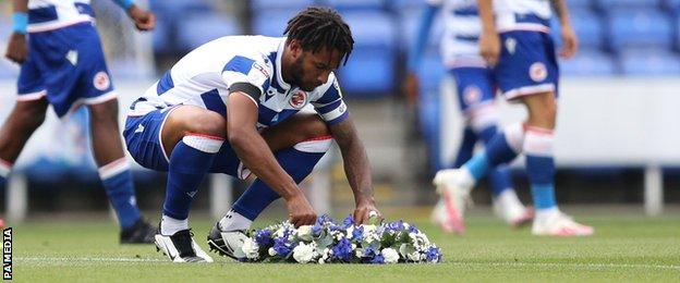 Reading captain Liam Moore lays a wreath