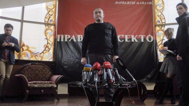 The leader of ultranationalist group Right Sector, Dmytro Yarosh, centre, pauses, during his press statement, in Kiev, Ukraine, Tuesday, March 25, 2014.