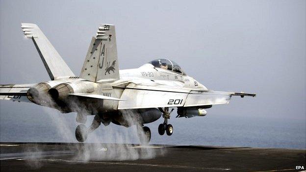 An FA-18 fighter bomber takes off from the flight deck of the US Navy aircraft carrier USS George HW Bush in the Gulf, 15 August