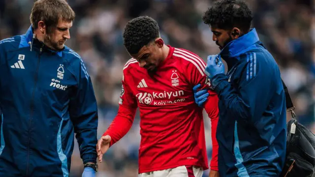 Morgan Gibbs-White walks off pitch with medical staff during Chelsea match