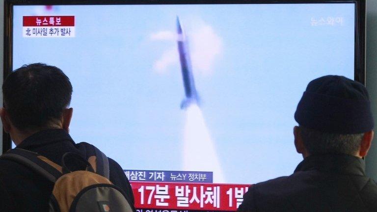 People watch TV reporting North Korea's missile test at Seoul Railway Station in Seoul, South Korea, 4 March 2014