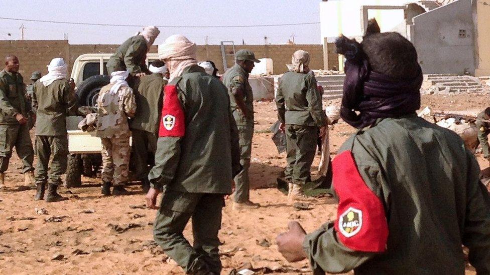 Soldiers attending to wounded and casualties in the aftermath of the suicide bomb attack