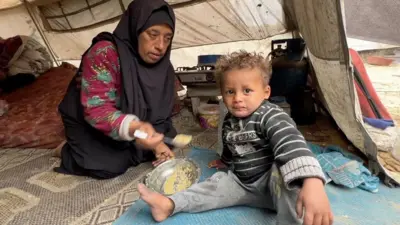 Salwa Abu Nimer with one of her child in Khan Younis