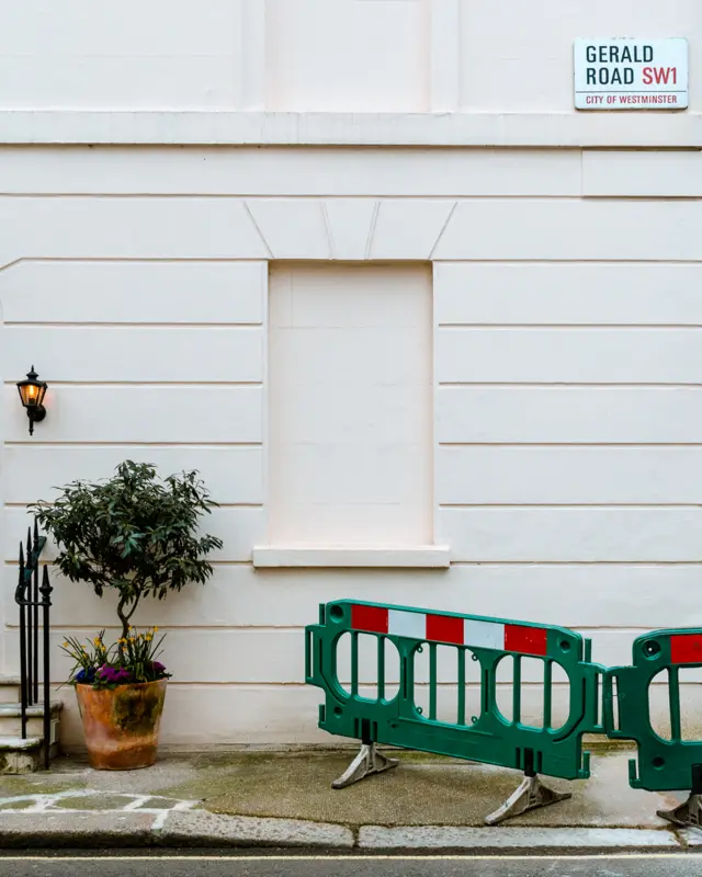 Single blocked window, with a plant and safety barrier beside it, at Gerald Road, London