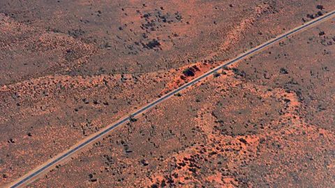 gionnixxx/Getty Images The Lasseter Highway, named after gold prospector Lewis Harold Bell Lasseter, runs through the Northern Territory's Red Centre (Credit: gionnixxx/Getty Images)