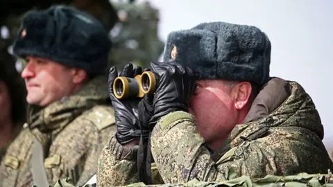 Getty Images A Russian commander looks on during military exercises in Crimea, 19 March 2021