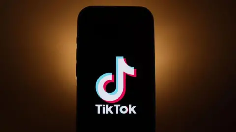 A phone with the TikTok logo