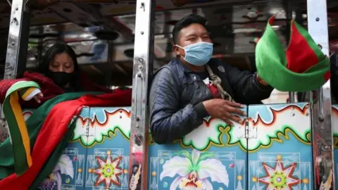 Reuters Colombian indigenous people travel on a bus to participate in a protest, Colombia October 18, 2020.