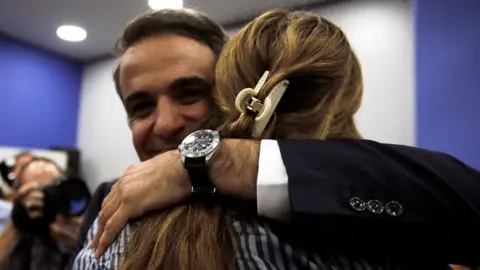 Reuters New Democracy leader Kyriakos Mitsotakis is congratulated at the party's headquarters in Athens, 6 July