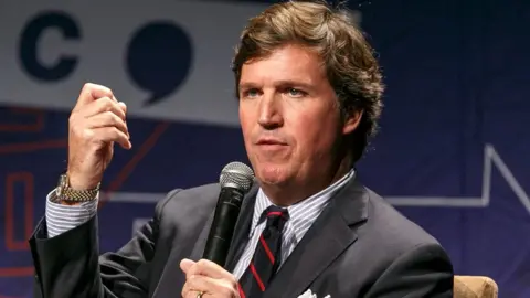 Getty Images Tucker Carlson speaks onstage during Politicon 2018 at Los Angeles Convention Center on October 21, 2018 in Los Angeles, California.