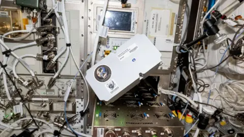 The SIL box is inside a space container. It shows it arrived safely on the space station.